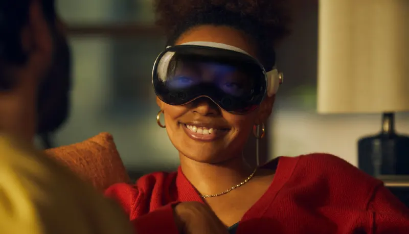 A womand smiling while wearing the apple vision pro